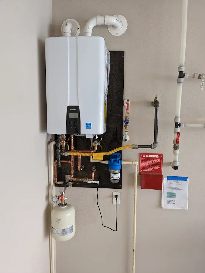 Professional plumber installing copper piping in a Huntington Beach home